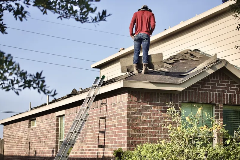 Professional roofer working on a residential roof in North Lexington